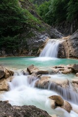Naklejka na ściany i meble waterfall flowing between mountains