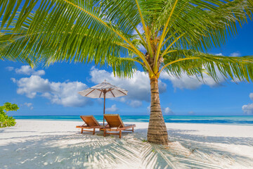 Amazing tropical island shore, two sun beds loungers, umbrella palm tree on white sand, sea view horizon. Luxury vacation, inspirational coast, sunny relaxation seaside. Beach resort hotel landscape