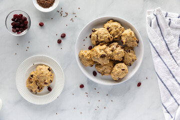 Top down view of a full platter of cranberry flax breakfast cookies with a small plate of cookies ready for eating.
