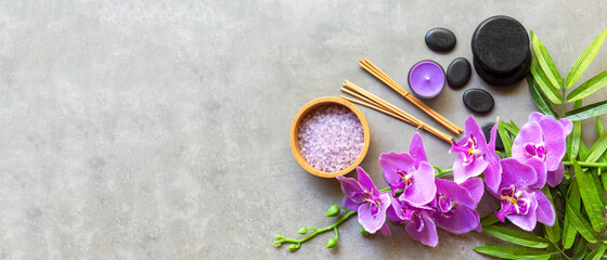Fototapeta na wymiar Thai Spa Treatments aroma therapy salt and sugar scrub massage with purple orchid flower on backboard with candle. Thailand. Healthy Concept. copy space for banner