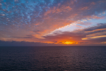 Fototapeta na wymiar Sunset in the sea with beautiful clouds. Sunrise ocean seascape.