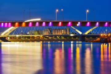 Fototapeta na wymiar Novi Sad, Serbia August 24, 2021: Rainbow bridge, Novi Sad, Serbia. Night reflection in Novi Sad