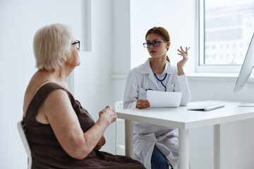 Fototapeta premium elderly woman with glasses examination by a doctor health care
