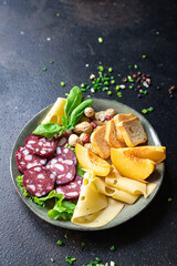 meat snack plate sausage, cheese, nuts, peach, fruit, toast bread smoked or dry-cured meal snack on the table copy space food background rustic keto or paleo diet