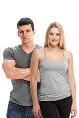Fototapeta premium Young happy athletic man and woman posing after training on white background