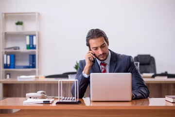 Young man businessman employee sitting in the office