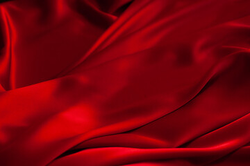 Naklejka na ściany i meble Red fabric texture background. Silk satin folds
