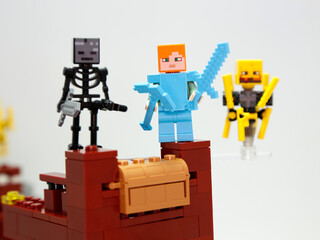 Obraz premium Minecraft. Alex, wither skeleton and blaze. Lego toys. Nether Fortress. Video game characters. Plastic dolls. Toys for children. Isolated white. Hero and Villains, mustruos, creatures. 