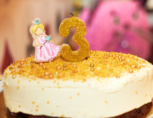 Third birthday of girl. Pink number 3 on birthday cake with princess. Happy birthday celebration...