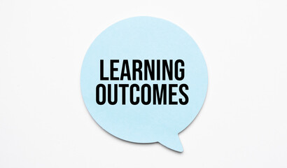 Learning outcomes speech bubble and black magnifier isolated on the yellow background.