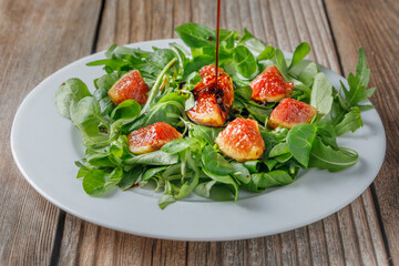 Healthy fig salad with lamb's lettuce and arugula and other vegetables.