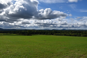 A green field under a cloudy sky, Sainte-Apolline, Québec, Canada