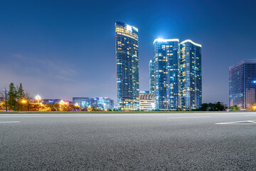 Panoramic skyline and empty asphalt road with modern buildings