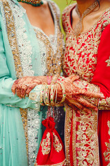 Naklejka premium hindu bride walks behind husband holding garb