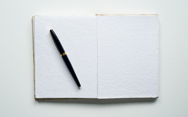 open notebook, space for text, rectangle, elegant pen, canvas texture, photo taken from above