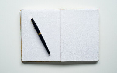 open notebook, space for text, rectangle, elegant pen, canvas texture, photo taken from above