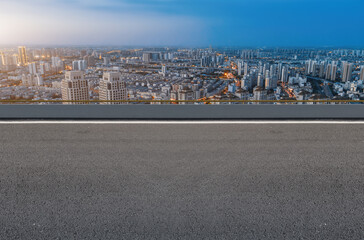 Panoramic skyline and empty asphalt road with modern buildings