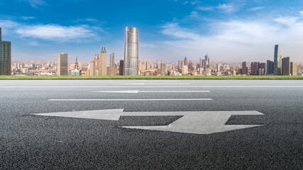 Panoramic skyline and empty asphalt road with modern buildings