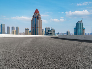 Panoramic skyline and empty asphalt road with modern buildings