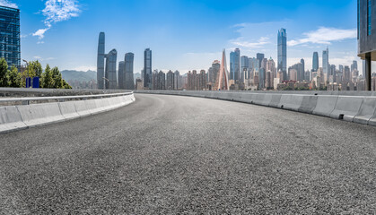 Panoramic skyline and empty asphalt road with modern buildings