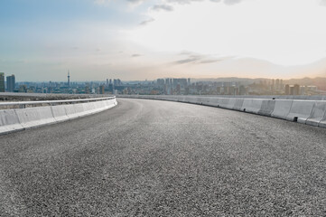 Panoramic skyline and empty asphalt road with modern buildings