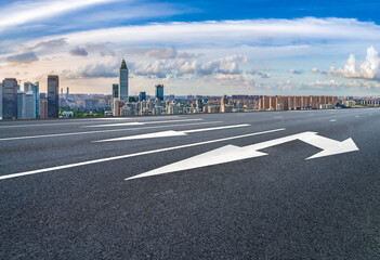 Panoramic skyline and empty asphalt road with modern buildings