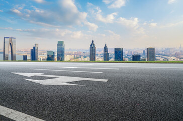 Panoramic skyline and empty asphalt road with modern buildings