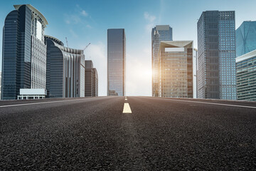 Panoramic skyline and empty asphalt road with modern buildings