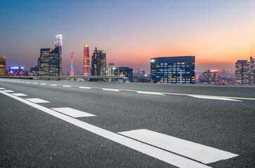 Panoramic skyline and empty asphalt road with modern buildings