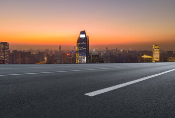 Panoramic skyline and empty asphalt road with modern buildings
