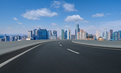 Panoramic skyline and empty asphalt road with modern buildings