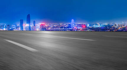 Panoramic skyline and empty asphalt road with modern buildings