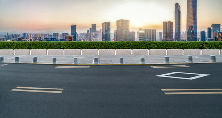 Panoramic skyline and empty asphalt road with modern buildings