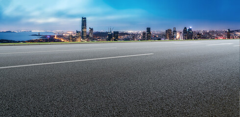 Panoramic skyline and empty asphalt road with modern buildings