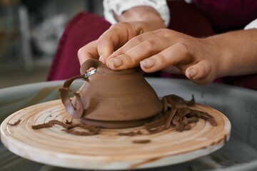 making ceramic pottery on a potter's wheel