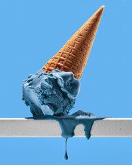 Blue ice cream in cone on blue background upside down and melting with drips