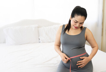 pregnant woman measuring tape her belly to check baby development. Healthcare and wellness. Health well being pregnancy lifestyle concept.