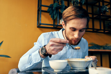 Man eating soup lunch snack in a restaurant