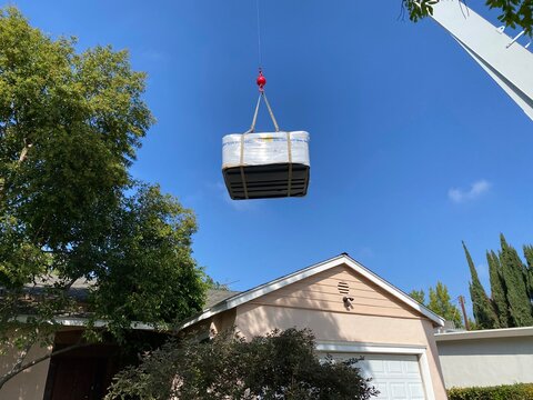 Cable on a crane delivering a hot tub