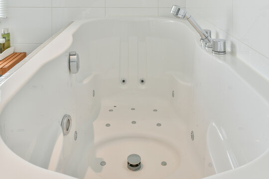 Bath with faucet in modern bathroom at home