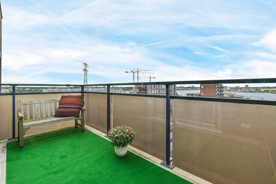 Balcony with potted flowers under cloudy sky - Powered by Adobe