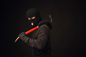 Portrait of burglair with crowbar