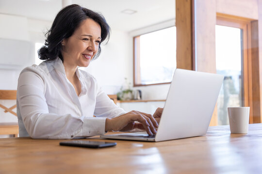Woman working on a project on the computer at home
