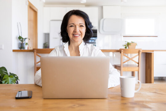 Woman working on a project on the computer at home