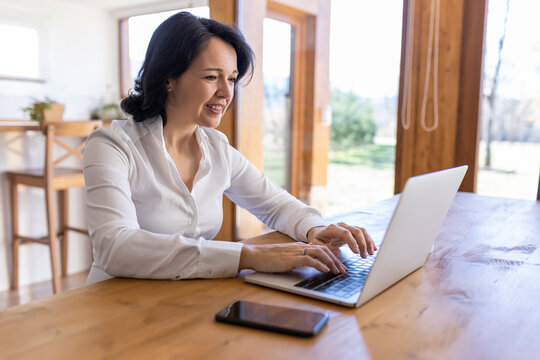 Woman working on a project on the computer at home