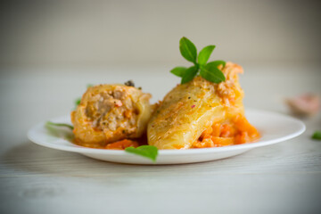 stewed in gravy stuffed peppers in a plate on a wooden table