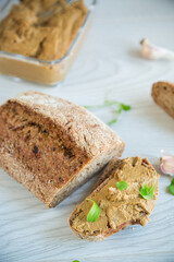 homemade liver pate with bread on a wooden table