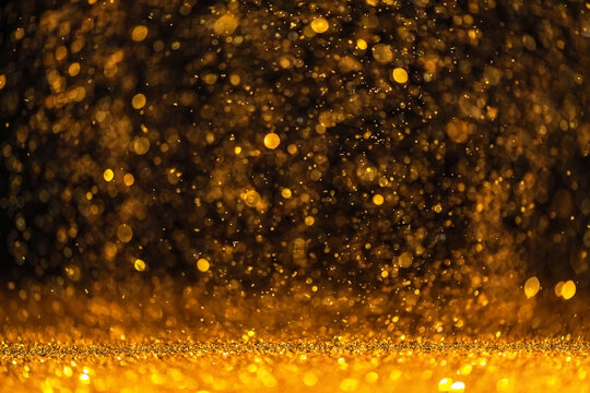 Gold Sequins Fall On A Black Background