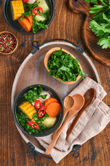 Chilean meat soup with pampkin, corn, fresh coriander and potatoes on old wooden table background. Cazuela. Latinamerican food.