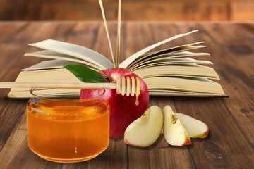 Red apples, honey and Torah book, Rosh Hashanah (Jewish New Year holiday) concept.